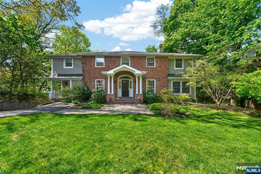 Timeless elegance defines this Center Hall Colonial, where classic architecture meets thoughtfully designed living spaces. A gracious foyer introduces beautifully scaled formal rooms, including a refined living room with fireplace and an elegant dining room ideal for entertaining. A possible first-floor guest suite or dual home office and a convenient first-floor powder room add flexibility and functionality for todayâ€™s lifestyle. The expanded chefâ€™s kitchen and adjoining family room form the heart of the home, enhanced by radiant heated floors, vaulted ceilings, and a striking wood-burning fireplace with gas starter. French doors open from the family room to a Trex deck, creating seamless indoor-outdoor flow. Upstairs, the serene primary suite offers a private retreat, accompanied by three additional well-appointed bedrooms and the convenience of a second-floor laundry room. The finished walk-out lower level with a fireplace, provides exceptional bonus space for recreation, work, or relaxation. With its gracious flow, refined details, and inviting ambiance, this exceptional home offers comfort, character, and timeless appeal- ideally located just moments from Ridgewoodâ€™s vibrant downtown, including restaurants, shops, top-rated schools and convenient access to NYC via train and bus.