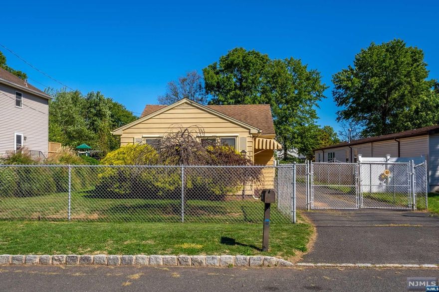 This two-bedroom ranch with a large yard is the perfect alternative to apartment living! Bring your vision and transform this home back to its original charm. Enter into a wood panelled front room perfect for use as a den or office. A french door opens to a spacious, sunny living room with wood style laminate floors. The eat-in kitchen with white cabinets and dark counters offers plenty of storage and prep space, stainless appliances and dinette area. Behind the kitchen is a convenient mud room & back door providing easy access to the yard and to the adjacent laundry and storage room. Two bedrooms and a full bath complete the living space. A large attic offers additional storage. The fenced in property includes a large detached 2 car garage, driveway space enough for 8 cars and a deep level yard perfect for relaxing or gardening! Convenient location is near to Duke Island Park, Rte 202 and Rte 22 for commuters, as well as Raritan Train Station.