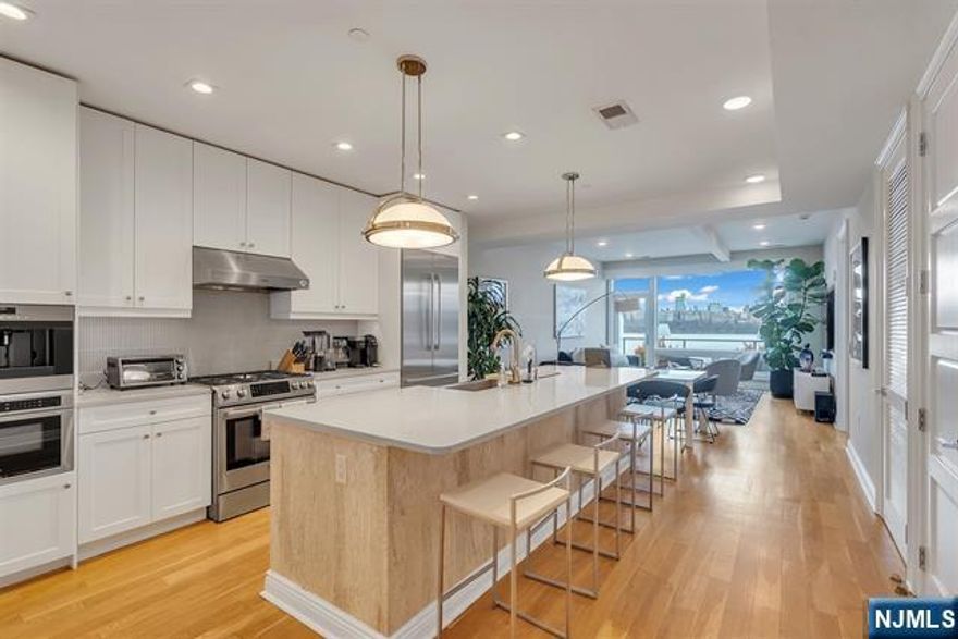 Perched on the top floor, this exceptional 3-bedroom, 2-bath residence offers a rare combination of elevated living, refined finishes, and sweeping NYC skyline views from nearly every room. Spanning approximately 1,430 square feet, the home features soaring ceilings and expansive windows that flood the space with natural light, enhancing the perfectly designed layout. The open-concept living and dining area flows seamlessly, ideal for both everyday living and entertaining, while the chefâ€™s kitchen is appointed with top-of-the-line appliances, sleek cabinetry, and premium finishes throughout. Each bedroom is generously sized, including a stunning primary suite with a spa-inspired bath designed for comfort and relaxation. Step outside to your private east-facing balcony, an incredible highlight, where unobstructed skyline views create the perfect setting for morning coffee or evening unwinding. Top-floor positioning offers added privacy and exclusivity rarely available in the building. Set within a highly desirable, amenity-rich community, this residence delivers the perfect blend of luxury, space, and lifestyle.