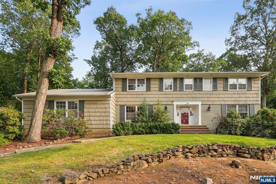 Elegant & expanded custom colonial perfectly perched on lushly landscaped grounds will astound. Enter into enormous sun drenched foyer that opens to elegant formal DR or spacious formal LR that continues into sunken glass multi purpose room--this home is an entertainers dream!! A generous sized FR anchors this amazing open floor plan home w/gorgeous wood burning FP. Updated Chef's kitchen with Quartz counter tops, SS appliances, pantry, double sinks & ovens & tons of cabinet & counter space--an all glass breakfast room w/sliders to sizable deck creates the best of indoor/outdoor living! This home will absolutely impress! The kitchen also has immediate access to garage, laundry, PR & main level bedroom/office. The upper level features a primary suite w/tons of closet space, dressing room & full bath. Three additional generous sized bedrooms w/ample closet space & a two room main bath complete the upper level. The LL offers large finished area for any and all types of entertainment & huge storage area and walk out. This stunning center hall colonial is charming & inviting and should not be missed!!