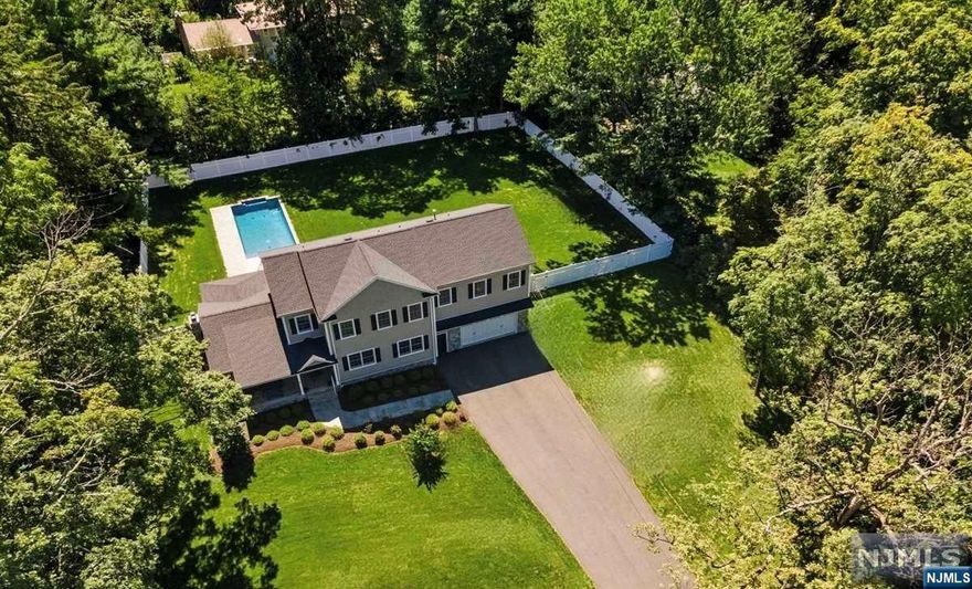 NEW CONSTRUCTION, masterful design & modern luxury are blended gorgeously in this custom Colonial home surrounded by natural beauty with a floor plan that combines contemporary openness w/functional spaces for a sturdy, luxurious & energy-efficient home. The interior features luxury finishes w/custom molding & trim, Anderson Windows & striking red oak flooring throughout. Vaulted ceiling & large windows in the great room, stone fireplace as the focal point. The gourmet chef's kitchen boasts high-end appliances, quartz counters & white cabinetry. Sliding glass doors in the sun-filled dining room open to a stone patio. Spacious primary suite w/a palatial en-suite bath & 2 sizable & very well-organized WIC. 3 additional bedrooms, each with WIC + full baths. As if this house was not impressive enough, some extras include Unite Heated Pool, whole-house generator, Smart Patio Pergola & top line Security System. Easy access to Rt 287, I78 & minutes from NJ Train to NYC.