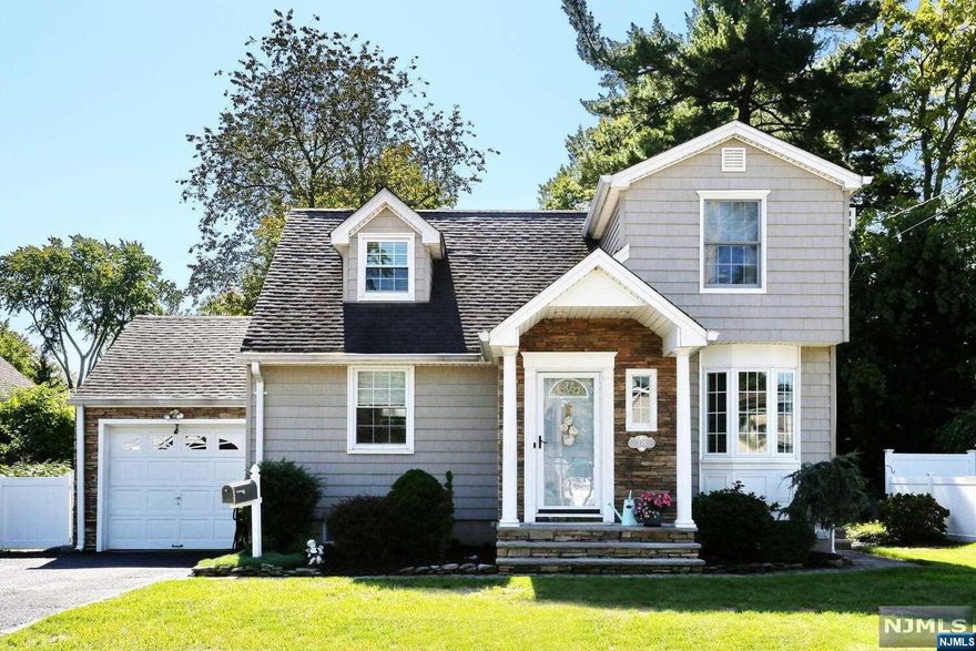 MOVE RIGHT INTO THIS IMMACULATE,LOVELY EXPANDED CAP COD HOME. RENOVATED AND FRESHLY PAINTED ALL NEUTRAL COLORS.FRONT FOYER WITH COAT CLOSET,LIVING ROOM WITH RECESSED LIGHTS AND BEAUTIFUL WOOD FLOORS. LARGE FIRST FLOOR BEDROOM WITH FULL WALL OF CLOSETS.NEWER FULL BATH AND NEW HALF BATH. FORMAL DINING ROOM, MODERN KITCHEN WITH STAINLESS STEEL APPLIANCES ALL OPEN TO FAMILY ROOM/DEN ADDITION WITH CATHEDRAL CEILING,RECESSED LIGHTS,AND GLASS SLIDERS TO DECK AND NICE SIZE BACKYARD WITH A POND AND CHARMING SIDE STONE PATH WAY WITH BEAUTIFUL HYDRANGEA PLANTINGS.SECOND FLOOR HAS 2 BEDROOMS AND PLENTY OF CLOSETS AND STORAGE SPACE.PARTIAL FINISHED BASEMENT WITH OFFICE SPACE AND STORAGE.EXTERIOR RENOVATED WITH EXPANDED FRONT STEPS AND COVERED PORCH WITH STONE FACED ENTRANCE WAY.PAVER WALKWAY AND EXPANDED DOUBLE DRIVEWAY, UNDERGROUND SPRINKLERS, WALK TO SHOPPING,SCHOOLS,AND BUSES TO NYC. OWNER HAS NJ REAL ESTATE LICENSE. (OIL TANK IS IN BASEMENT NOT UNDERGROUND)