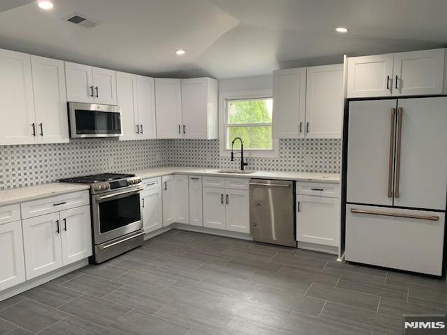 Updated Contemporary Style Living In Sought After Area Of Ridgefield Park! Open & Generously Sized Great Room Which Flows Into a Separate and Equally Spacious Dining Area. Entire First Floor Receives Abundant Natural Light Due to Brand New Windows Throughout The Home. Recessed Lighting, Gleaming Hardwood Flooring Updated Electric and Brand New HVAC System. All Upgraded Appliances in The Kitchen Coupled With Granite Countertops and a High Cathedral Ceiling. A Huge Urban Oasis Is Your Backyard With Multiple Gardens and Grass Areas! Parking for Multiple Vehicles Plus a Two Car Garage With a New Roof. EZ Access To NYC, NJ Tpk, Shopping and All The Area Has To Offer!