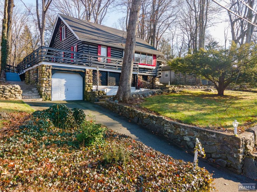 Less than an hour from NYC sits this iconic Chestnut Log Cabin with pecky cypress paneling. Be part of beautiful Cupsaw Lake with beach, fishing, electric boating, swimming, beach club, community center and so many activities. Set overlooking the beach and lake enter into the DR & LR with stone masonry wood fireplace. The oversized kitchen opens up to the large deck in the tranquil backyard. Two bedrooms, one that has been used as the master, and a full bath complete the sunlit first floor. The upper level has two large bedrooms with voluminous ceilings. A real treat and not common in a log cabin is a finished basement with bonus room, custom-made bar along with utility room and laundry room! A great place to live- make Cupsaw Lake part of your life! Home, where we work, teach, live and love! Hardwood floors under carpet on first floor and also top floor right bedroom. New septic to be installed prior to closing.