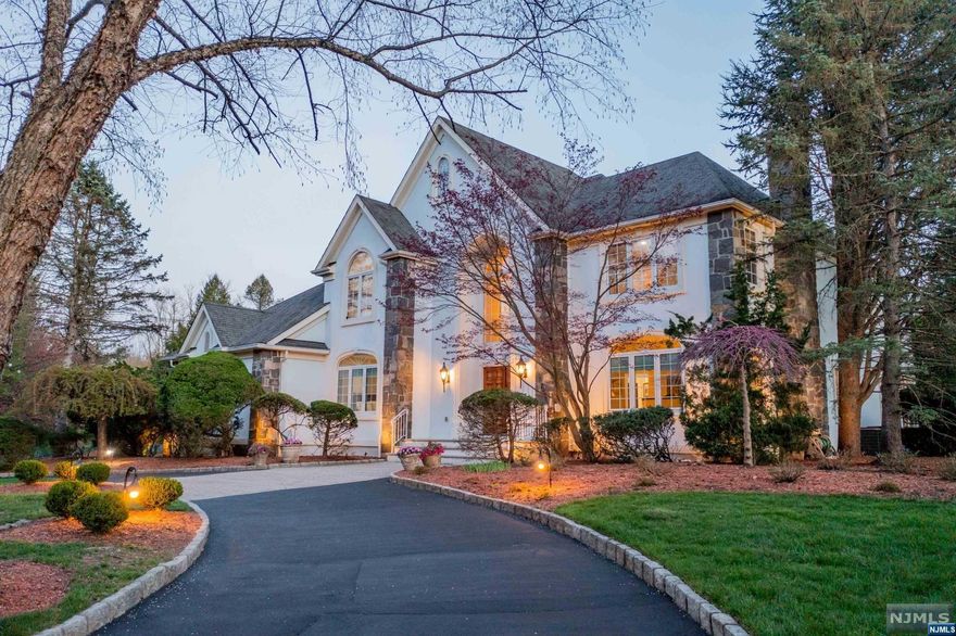 Set on a highly coveted cul-de-sac in Upper Saddle River, this grand manor colonial exudes elegance & sophistication. Boasting a generous 5 bedrooms & 5.5 baths, this residence offers an unparalleled level of luxury. Upon entry, the 2-story foyer welcomes you into a home of grand proportions. The main level features a formal LR, a gracious DR, a heated sunroom, kitchen with breakfast area, & a remarkable 2-story great room adorned with a fireplace, wet bar & doors to oversized deck. Additionally, this level includes a bedroom suite, powder rm, & laundry/mud rm. The second floor unveils a luxurious primary ste with a sitting room, a junior ste with its own sitting rm, two large BRs connected by a Jack & Jill bath, & a BR/office. The lower level is an entertainer's dream, offering a rec room with wet bar, bonus room with full bath, theater with stadium seating, gym, & a playroom/office. Fully fenced yard, circular driveway, 3-car garage. 5,321 square feet not including lower level!