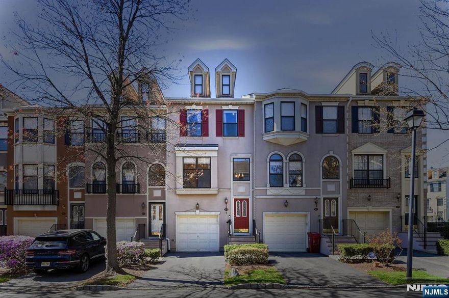 Beautifully renovated tri-level townhome in the highly desirable Cambridge Heights community, offering approx. 2,010 sq ft of light-filled living space. This turnkey home features 2 bedrooms and 3 full plus 1 half baths, including a full bath on the walk-out lower level ideal for guests, recreation, or flexible living. The main level showcases an updated kitchen (2020) with custom wood cabinetry, designer fixtures, and a center island open to the living area. A spacious family room with gas fireplace, formal dining room, powder room, and great storage complete this level. Upstairs offers two generously sized bedrooms, two full baths, laundry, and abundant closets. High ceilings and oversized windows bring in beautiful natural light throughout. The lower level provides additional living space with direct access to a private patio and outdoor area, plus access to the garage. New Roof (2026) and recent updates include fresh neutral paint, upgraded flooring (2023), new HVAC (2022), and water heater (2024).Cambridge Heights is a gated community located just 9 miles from NYC, offering a resort-style lifestyle with pool, clubhouse, fitness center, tennis courts, playground, and beautifully maintained grounds. Easy access to NYC bus, train, and major highways makes this a commuter's dream.