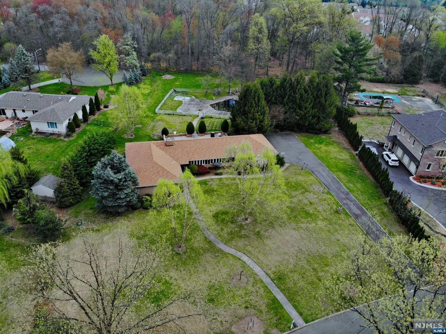 AMAZING RARE OPPORTUNITY TO LIVE IN THE MOST DESIRABLE NEIGHBORHOOD IN PARAMUS SET ON A MASSIVE 1.45 ACRE LEVEL PROPERTY. THIS 4 BEDROOM 3 BATHROOM RANCH IS THE PERFECT CANVAS TO BUILD YOUR DREAM HOME. LARGE BRIGHT ROOMS THROUGHOUT WITH PLENTY OF NATURAL LIGHT FLOWING THROUGH THE HUGE WINDOWS. LIVING ROOM OPENS THROUGH SLIDING GLASS DOORS TO THE PRIVATE, PICTURESQUE, PARK LIKE BACKYARD WITH LARGE PATIO, SWIMMING POOL AND PLENTY OF SPACE TO ENJOY. MASSIVE OPEN FULL FINISHED BASEMENT FEATURES LARGE WET BAR AND REC ROOM PERFECT FOR ENTERTAINING. THIS HOME AND PROPERTY ARE A MUST SEE.