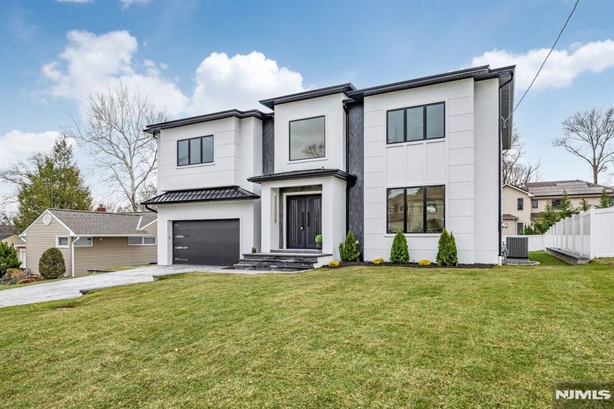 Introducing a newly constructed luxury residence in one of Paramusâ€™s most desired neighborhoods. This exceptional home seamlessly blends modern sophistication with thoughtful design, offering 6 spacious bedrooms and 6.5 luxuriously furnished bathrooms. A grand two-story foyer creates a striking first impression, flowing effortlessly into an elegant formal dining room. The main level is defined by soaring ceilings and a luminous open-concept layout, connecting the living room, a state-of-the-art gourmet kitchen, and a sun-drenched great room framed by oversized windows that fill the space with natural light. A private first-floor guest suite provides both comfort and convenience. Upstairs, an open hallway overlooks the foyer and is enhanced by a statement window, creating an airy, refined ambiance. Four generously sized bedrooms, each with its own en suite bath, complement the luxurious primary suite, complete with dual walk-in closets and custom built-ins. The fully finished lower level is designed for elevated living and entertaining, featuring high ceilings, a spacious recreation area, home gym, private theater, additional suite, and a sleek wet barâ€”perfect for hosting or everyday enjoyment. This is a rare opportunity to own a thoughtfully designed , move-in-ready luxury home in the heart of Paramus.