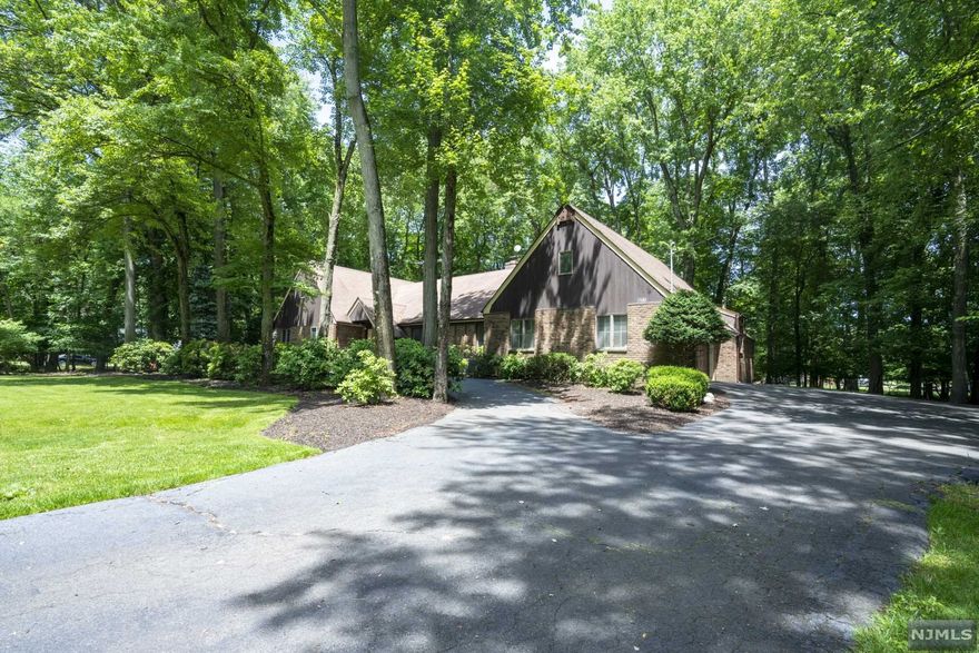 Welcome to the town of Franklin Lakes where this updated four bedroom and three bath ranch sits privately on almost an acre of land. This home is well equipped with state of the art appliances and exquisite tile work. New septic and generator are in place on this beautiful home.