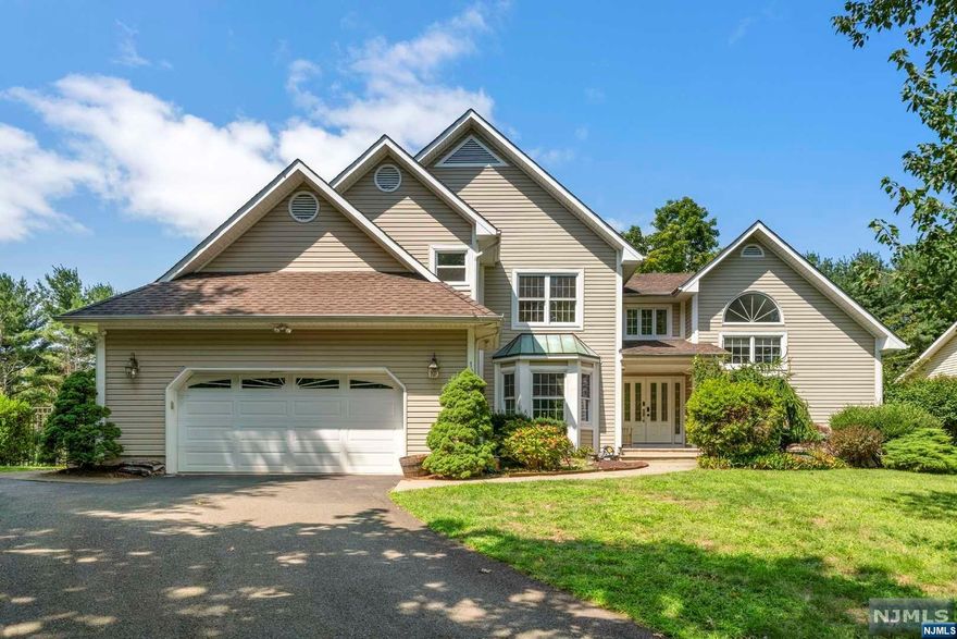 Excellent Location! Boasting 4100+ sq ft of living space and a total of 5 bedrooms, 4 baths, this east-south facing Colonial property with Private RESORT-LIKE BACKYARD . Columned front entry leads into a main level with hardwood floors, great rooms w/ high vaulted ceilings, recessed lighting and more. First-floor has an eat-in kitchen, living room with fireplace and large deck to backyard and 1 bedroom/ office, new modern full bath and access to the main-floor laundry and 2 car garage. Upstairs you'll find a primary suite with a huge bedroom w/vaulted ceilings, walk-in closets and spacious bath with custom tile, dual quartz-topped vanity, clawfoot tub and separate shower. Three more bedrooms are serviced by a full hall bath. Full finished ground level offers a huge rec room with bar, full bath, bonus room as a gym, plenty of storage space. Newly updated pool and spa, playground, pond, and basketball court perfect for relaxing in the sun, gardening and games.This great value house!