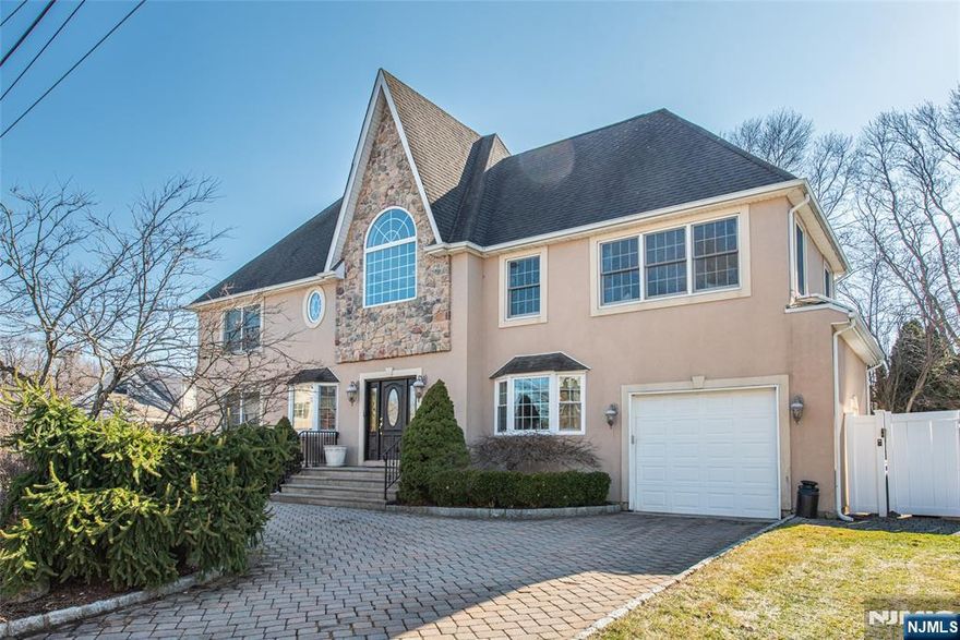 Beautifully renovated 4 bedroom Colonial offering a perfect balance of classic design and modern updates. The home features an impressive great room with cathedral ceilings, creating an open, light-filled space ideal for both everyday living and entertaining. The primary suite is a true retreat, featuring high ceilings, charming built-in window seats, a spacious cherry walk-in closet, and a private balcony overlooking the resort-like backyard. The suite also includes a luxurious en-suite bath with a jetted tub and an updated shower with handheld fixtures, creating a spa-like space to relax and unwind Additional bedrooms are generously sized with ample closet space and high ceilings. Step outside to a private backyard oasis featuring a kidney-shaped saltwater pool and hot tub , perfect for relaxing or entertaining. The outdoor space also includes a gas grill area and firepit, ideal for summer gatherings and outdoor dining. Additional flexible living space offers possible in-law potential, providing options for extended living, guests, a private work-from-home setup or a area for the teens to hang out. Close to NY transportation and walk to shopping and schools.