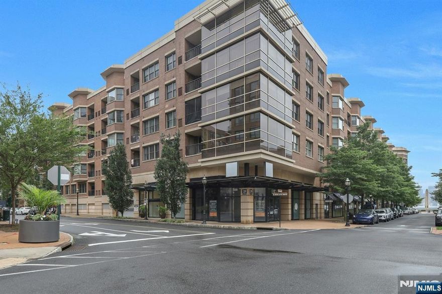 Welcome home to this incredible light filled, 2BR 2BA spacious corner unit! Enjoy a glass of wine and the astonishing NYC and Hudson River views from the spacious private balcony. Luxury finishes include hardwood floors, stainless steel appliances, and stone counters! Ensuite main bedroom with large walk-in closet and bathroom with Jacuzzi ! Washer/Dryer in-unit and One Car Garaged Parking included! Grandview II is a full service complex in a prime Hudson Waterfront Location with 24hr Concierge, Fitness Center, Community Courtyard with Outdoor Pool! Easy access to Manhattan via bus, light rail or ferry! Shops, restaurants and supermarket are located on premises!