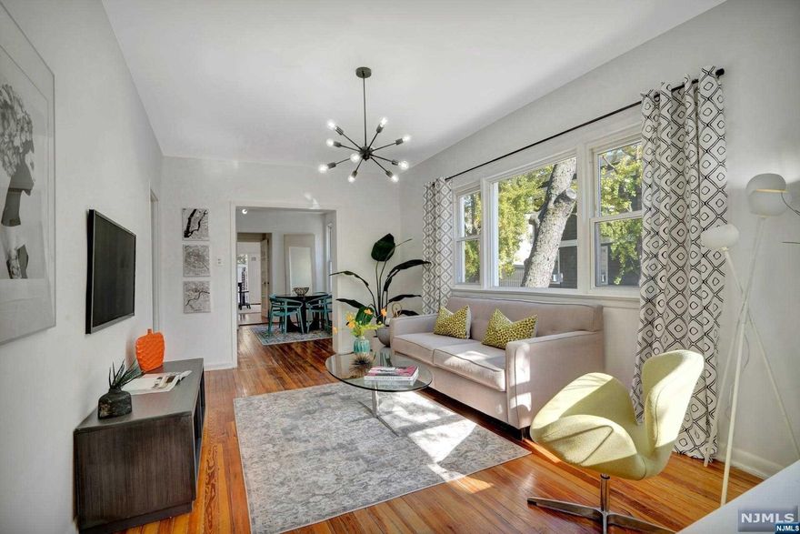 Welcome to this well-maintained two-family home sitting on a corner property a block away from prestigious Blvd East! Drenched in natural sunlight, this home features two units with separate utilities. Enter the foyer sunroom into the first floor unit living room with sun drenched windows allowing for an abundance of natural light followed through to the dining room area, leading into the fully equipped kitchen with direct access to the backyard patio. Two generously sized bedrooms, closets for storage and one full bath complete the unit. Upper second unit features open concept living and dining room wrapped around with windows, kitchen, spacious 2 bedrooms and a full bath. Both units have hardwood floors and access to the common laundry in the basement. Semi basement with dual access with potential duplex have endless possibilities. Full brick detached rare double garage. Perfect location, with one block to prestigious Blvd East and direct access to NYC, a commuter's dream.