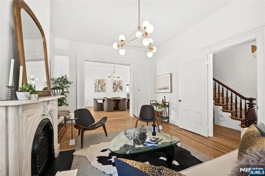 Experience the grandeur of this rare, newly renovated Queen Anneâ€“style Victorian with porch, set on an oversized lot on one of Jersey City Heightsâ€™ most picturesque blocks. This expansive 7-bedroom, 4.5-bath pre-war home blends original charm with modern functionality, exceptional scale, and rare parking. Original hardwood doors and trim welcome you into a space filled with timeless detail, including refinished parquet inlay floors, crown molding, 11â€™ ceilings, and preserved pocket doors connecting the living and dining areas. The living room features a carved marble mantle, while oversized windows and a bay alcove flood the dining room with natural light. A Lincrusta chair rail enhances the historic appeal. The kitchen offers custom cabinetry, a Sub-Zero refrigerator, 6-burner Wolf stove, vented hood, Sharp microwave, Viking dishwasher, and wine fridge, plus an adjacent sunroom. The second level includes a spacious primary suite with ample closets and a spa-like en-suite bath with double vanity, soaking tub, and glass shower, plus two bedrooms and a full bath. The third floor adds three bedrooms, a laundry room with LG washer/dryer, and a full bath with NYC skyline views. The finished ground floor offers a 1-bedroom, 1-bath suite with Bosch appliancesâ€”ideal for guests or extended living. Outside, enjoy a landscaped yard, 2-car garage, and parking for 4â€“5 cars. Near Pershing Field, Central Ave, and NYC transitâ€”this is a rare opportunity to own Jersey City history.