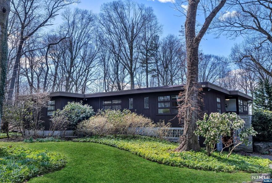Experience the pinnacle of Mid Century Modern luxury at 470 Highview Rd. in Englewood, NJ a haven where sophistication meets the vibrant energy of Manhattan, just 20 minutes away. Nestled on over 2 acres of meticulously landscaped grounds, this architectural gem offers more than just a home it's a lifestyle. Step into tranquility within this 4-bedroom, 3.5-bathroom residence, where floor-to-ceiling windows invite the beauty of nature indoors, creating a serene ambiance that envelops you upon arrival. Outside, a shimmering pool beckons amidst lush landscaping, providing the perfect retreat for relaxation and rejuvenation. Discover the perfect balance of luxury and convenience at 470 Highview Rd., where suburban charm meets urban allure, with a bustling downtown area offering an array of international eateries, artisanal bakeries, and chic boutiques just moments away.