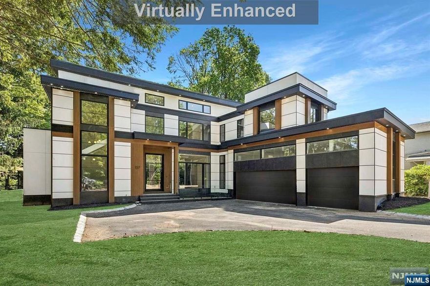 <<<<CONTACT LISTING AGENT ANAT 201.341.4765- EISENBERGANAT@GMAIL.COM >>>Modern new construction at the heart of Tenafly's East Hill on a half-acre lot. 6 spacious bedrooms and 6.5 luxurious bathrooms, this property is perfect for those seeking space, comfort & privacy. Enjoy sleek modern elegance & sophistication with an impressive 7800 s.f of living area. The 1st floor features 11-foot ceilings, and 6-inch wide plank hardwood floors, adding to the sense of grandeur. The Italian-made kitchen, outfitted with stainless steel appliances, includes a large island and ample counter space, perfect for hosting dinner parties or preparing a delicious family meal. An exquisite one-bedroom suite is a great addition. Exterior showcases porcelain tiles and Stucco. Amenities include a 3-car garage, an in-ground pool, a covered patio with an outdoor kitchen, a home theater, and a gym.