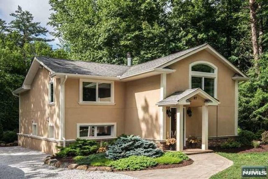 Live in your own private sanctuary! This updated home features a secluded, landscaped yard with an outdoor kitchen and stone patio for seamless indoor-outdoor living. The main level boasts a family room with a cathedral ceiling and a wood-burning fireplace, plus the master bedroom and two bedroomsâ€”all with elegant wood flooring. A modern eat-in kitchen with a large island, stainless steel appliances, and a handy pantry, plus a dining room with a marble floor, are located on the ground floor. Enjoy a short 15-minute drive to Mountain Creek and other recreational activities. Storage and a shed outside