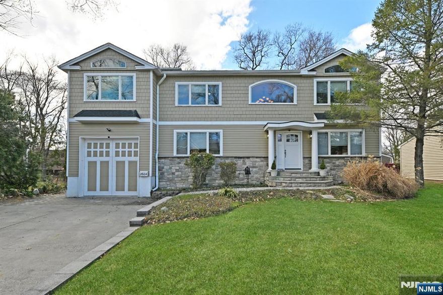 Beautifully updated 5-BR, 4-BA home offering approx. 2,991 sq ft of sun-filled, open-concept living plus approx. 1,200 sq ft finished lower levelâ€”truly a home that invites you to settle in and stay. A welcoming two-story entry unfolds into spacious living and dining areas, leading to a stunning new white kitchen with abundant cabinetry, waterfall peninsula, stainless steel appliances, and designer finishes. Andersen windows throughout bathe the home in natural light, while French doors provide effortless access to the outdoors. The main level features a bedroom and full bath, perfect for guests or extended living. Upstairs, 4 bedrooms include a serene primary suite with tray ceiling, private balcony, walk-in closet, and spa-like bath, plus a junior en-suite, hall bath, and laundry. The finished lower level offers a family room, office, craft space, laundry hookup, and storage. Set on a deep, private property with deck, patio, fire pit, and storage shed, all near a popular park, major highways, and approx. 1 mile to NYC bus and train. --