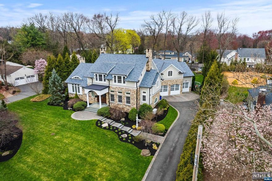 Nestled on one of the best blocks in all of Hartung, this custom home of approx 5,500 sq. ft. epitomizes perfection. Its exterior showcases high end stone work and copper trim, with mature landscaping and privacy hedges. Inside the home, exquisite millwork, build-ins and plantation shutters adorn every room.. Enjoy an open floor plan, gourmet kitchen, vaulted ceiling family room with french doors overlooking private backyard with saltwater pool and outdoor kitchen. With a first floor bedroom and adjacent full bath, convenience is key. Private primary suite and three other oversized bedrooms round out the upstairs. The full finished basement boasts a full kitchen/bar, family room, home gym with sliding glass doors, full bath, and bonus bedroom. Walking distance to the elementary school and NYC transportation at the edge of the neighborhood Schedule a private tour today.