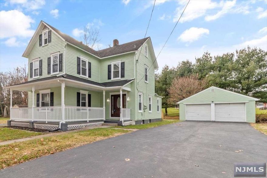 The charming home was renovated & upgraded to modern design. One is first greeted by the wrapping front porch, perfect for lounging on hot days & unwinding on cool nights. Upon entering, one is welcomed into the contemporary foyer adorned w/ an illuminated recessed wall shelf & a large drop ceiling edge lit w/ LED lights. The 1st Fl is truly an entertainer's thrill w/ the Dining Rm, Living Rm & Family Rm flowing uninterrupted. The kitchen is gorgeous & functional w/ its 2 tone shaker cabinets, white granite counters, intricate backsplash & new S.S Appl. The 2nd Fl hosts 3 bedrooms & a full bath w/ custom tiling & double sink vanity. The spacious attic has pull-down stair access. The semi-finished basement adds more SqFt for storage & recreation. There is central AC & forced heating. There is a brand new, city approved septic system. There are also many modern light fixtures & recessed lights throughout. The exterior has a vast property lot, two garages & generous driveway.