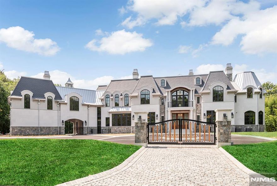 A masterfully crafted French Provincial Estate nearing completion in Alpineâ€™s prestigious Rio Vista. Situated on a prime south-facing lot with views of Montammy Country Club, this 8BR, 9FB, 2HB residence spans four levels with elevator access and offers timeless design and livability. Exterior features include Synthetic Slate Roof, Connecticut-cut granite, Turkish Limestone, and Italian Porcelain Terraces. The backyard oasis boasts a 20' wide infinity-edge pool with ongrade wading pool and a heated Loggia with Phantom Screens for year-round use. The lower level is a wellness retreat with a sport court, gaming lounge, spa suite with infrared sauna, steam & massage rooms, and full gym. Additional highlights: 6 fireplaces, ensuite bedrooms, finished attic, home office, surround sound, security system, and partial walk-out lower level. Designed to be lived in and built to the highest standardsâ€”this is luxury redefined.