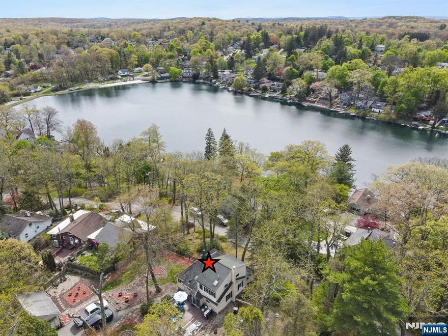 NEW PHOTOS HERE! Vacation every day w/ peaceful lake views & a short walk to highly desirable Lindy's Lake beach- a private spring fed lake of 20+acres. The value here is in the location & spacious double lot size. You need to experience this property in person to appreciate it! Charming expanded log home features high ceilings, open living, stone fireplace, lots of natural light, 2 lg bedrms & tons of storage on .57 acre of picturesque yard. Perfect to move in or great expansion potential on this sizable lot. The inviting interior blends rustic charm with an open warm feel. Step outside to a storybook backyard that calls you to relax in tranquility or crank it up as the yard is designed for entertaining w/multi outdoor gathering areas. A walkout partial basement provides added storage & more potential. A detached 2-car garage (needs repair) offers potential for a studio, home office, workshop, guest space or expansion. Lg driveway w/ample parking (enters frm Hudson Dr) Double lot size offers space & lots of potential. A unique opportunity w/charm, space, tranquility & endless possibilities all within a short walk (approx .2 miles) to Lindys Lake Beach. Approx 41 miles from NYCw/Commute options. Value is in this LOCATION AND a rare DOUBLE LOT SIZE PROPERTY. Home sold as-is.Fireplc/chim/flue is as is-no known issues. Every day is vacation in this lovely home & lake community! Lindys Lake offers lifeguarded beach, boat/kayaking,fishing & many events including a Polar Plunge!