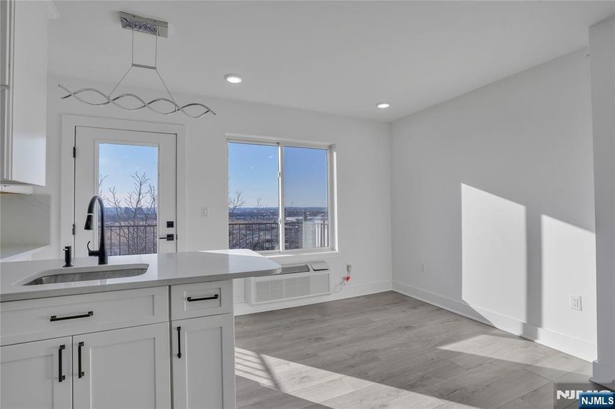 CORNER PENTHOUSE with PRIVATE TERRACE and open exposures on all sides, offering exceptional natural light and sweeping MEADOWLANDS VIEWS from its top-floor position. Meadowview Residences is a NEW CONSTRUCTION 12-unit ELEVATOR building perched high. This 2 BEDROOMS + DEN/OFFICE WITH ITS OWN WINDOW and 3 FULL BATHS features an OPEN CONCEPT layout, modern kitchen, and in-unit laundry. PREMIUM INDOOR GARAGE PARKING with comfortable maneuverability available. Minutes to MANHATTAN via public transportation.