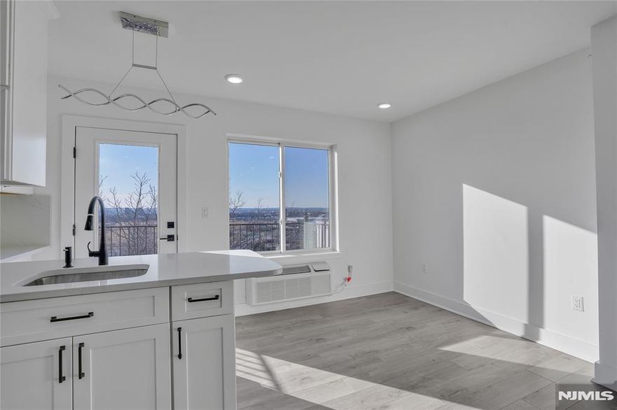 CORNER PENTHOUSE with PRIVATE TERRACE and open exposures on all sides, offering exceptional natural light and sweeping MEADOWLANDS VIEWS from its top-floor position. Meadowview Residences is a NEW CONSTRUCTION 12-unit ELEVATOR building perched high. This 2 BEDROOMS + DEN/OFFICE WITH ITS OWN WINDOW and 3 FULL BATHS features an OPEN CONCEPT layout, modern kitchen, and in-unit laundry. PREMIUM INDOOR GARAGE PARKING with comfortable maneuverability available. Minutes to MANHATTAN via public transportation.