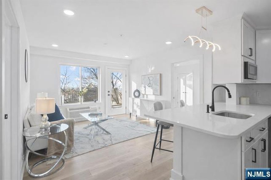 Meadowview Residences is a NEW CONSTRUCTION 12-unit ELEVATOR building perched high with sweeping MEADOWLANDS VIEWS and open exposures on all sides. This CORNER PENTHOUSE features 2 BEDROOMS plus a DEN/OFFICE WITH ITS OWN WINDOW and 3 FULL BATHS. OPEN CONCEPT layout filled with natural light and a PRIVATE TERRACE. Modern kitchen and in-unit laundry. Tucked away yet minutes to MANHATTAN via public transportation. PREMIUM INDOOR GARAGE PARKING with comfortable maneuverability available for purchase.