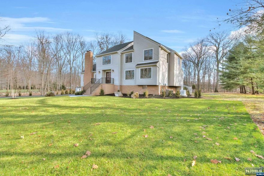 Set in a prime Bergen County neighborhood, its captivating curb appeal is accented by stunning updates and thoughtful details where natural light floods the home on every level.This beautifully renovated Contemporary style home offers elegance and warmth.The grand entrance hall leads to oversized front to back great room with fireplace and large windows overlooking level lot with in-ground pool. Sumptuous primary bedroom suite suite on the second level with walk-in closets and beautiful new bathroom with heated floor. Modern brand new kitchen with large waterfall island countertop.New hardwood floors, finished basement, 22KW natural gas generator and more... Great location with short distance to Ramapo High School and major New Jersey highways.