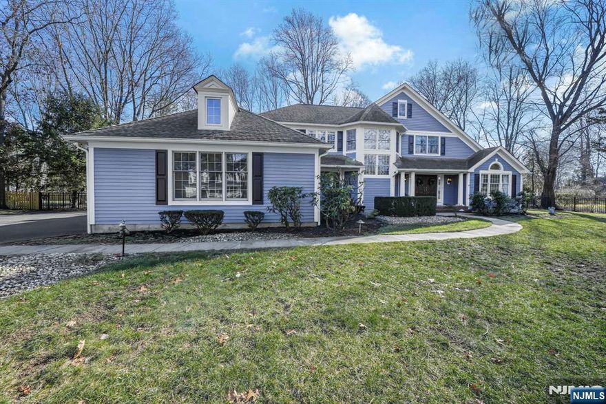 This sun-filled Colonial showcases timeless design, quality craftsmanship, and a thoughtfully designed floor plan, all set on a flat lot in a sought-after neighborhood. A welcoming interior features a winding staircase, hardwood floors, and an abundant amount of natural sunlight throughout. The gourmet eat-in kitchen boasts granite countertops, a center island with seating, custom cabinetry, and high-end appliances, seamlessly opening to the family room with a charming wood burning brick fireplace. Sliding doors lead to a spacious wood deck ideal for outdoor entertaining. Upstairs, the primary suite offers a luxurious bath with a large stall shower and separate soaking tub. Three additional bedrooms and a full bath complete the second floor. The fully finished basement provides additional living space, perfect for a recreation room, home office, or gym. Located within walking distance to Lake Valhalla Club, this home combines an exceptional neighborhood setting with elegant design and modern amenities.