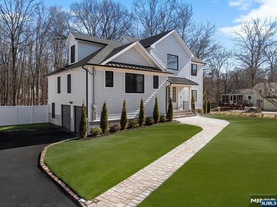 Welcome to this beautifully renovated Custom Split 5-bedroom, 5.5-bath home in Livingston, NJ. This stunning new construction features a spacious open-concept layout, perfect for modern living. The chef's kitchen boasts top of the line Thermador appliances, sleek countertops, and custom cabinetry, and stunning walk-in butler's pantry. Enjoy the luxury of a large primary suite with a spa-like bath. Additional office space on third level and bonus room en suite on lower lever with sliders walk-out to fully fenced in yard. Enjoy seamless indoor-outdoor living with a gorgeous Trex deck, perfect for relaxation and entertaining. With a 2-car garage, ample storage and premium finishes throughout, this home is ready to welcome its new owners. Located in a sought-after neighborhood with excellent schools, parks, and easy access to major highways. Don't miss this gem!