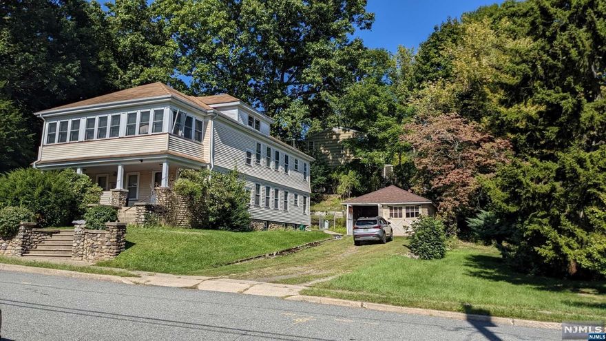 Rare 2-family Bloomingdale home w/detached 2 car garage.Corner location w/partially fenced yd. Extra lg corner property w/stone wall in front.Covered front porch.Both units w/ 3 bedrooms,full bath, kitchen,living room & dining room, plus extra closets.Downstairs unit w/ beautiful chestnut front entryway w/stairs Both units w/ original chestnut trim,wood panel doors, & pine flooring thuout. Upstairs unit w/additional front 3-season porch & access to huge walk-up attic.Lower unit w/ access to partially finished bsmt w/summer kitchen, full bath & loads of storage & large closets. All appliances are included but sold as is.Stove in summer kitchen will be removed prior to closing.Both units w/separate electric meters.Upstairs unit is nat gas heat.Downstairs unit is oil. Newer above ground Roth oil tank in basement.Gas boiler for upstairs unit is newer Well McClain.Both units have natural gas water heaters. 2 small window A/C units included.Both units are on same water meter.