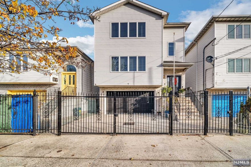 Welcome!!! Welcome!!! Spacious Newer two-family home conveniently located in the sought-after Ironbound section of Newark. Everything is just steps from your door, while close to all major public transportation with "EASY NYC COMMUTE " This well-kept Newer two-family home features: Two apartments Top/Bottom, plus a sizeable recreation room, each apartment has a kitchen-living /Dining room combo, three bedrooms, two full baths, plenty of closet space, hardwood flooring throughout, crown molding, Stainless Steel Appliances, and laundry at ground level. Two car garage with Driveway, Central heating & Air Conditioning, fenced-in cemented large back yard