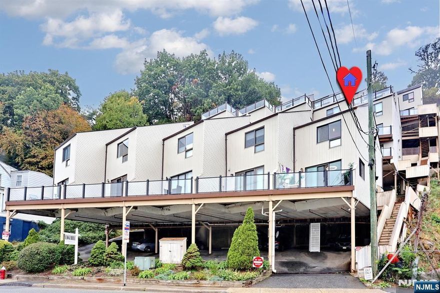 Welcome to Edgehill's 1st level end unit two-bedroom that offers beautiful Hudson River and NYC views. The location is highly desirable, situated directly across the street from Edgewater's Veterans Field. The 1st level features a modern, updated kitchen complete with granite counters and a dining area. This floor also houses a large living room with access to a deck, as well as an updated powder room. Moving to the upper level, the spacious master bedroom is a highlight, boasting custom closets and high ceilings This floor also includes a full bathroom, a second bedroom with custom closets, laundry facilities, and easy access to a large attic for storage. Renovations and upgrades completed in 2023 include new kitchen, appliances, bathroom vanities, washer and dryer and HVAC. Additional benefits include hardwood floors throughout, low HOA fees one covered parking space.and exceptional commuter access, with an express bus stop right in front of the building. It is also conveniently located near schools, shops, parks, the ferry, and public transportation.