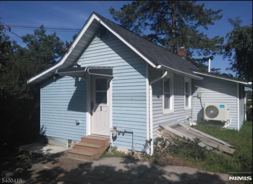 Discover this cozy, stand-alone 1-bedroom cottage perfectly situated in an unbeatable location! This clean and efficient home features a comfortable bedroom, a small office/storage room, and an open-concept living/dining area with a convenient kitchenette. Enjoy the ease of an in-unit full bath and washer for everyday comfort. Located directly across from Acme and local shops, you'll have everything you need just steps away. Commuters will love the proximity to the train station, downtown area, NJ transit buses, and direct NYC bus and train options. Major highway access is only minutes from your door. Energy-efficient ductless electric heating and cooling help keep utility costs low. Tenant pays electric only. Additional features include.. Small private yard and patio exclusively for tenant use & On-site driveway parking for up to 2 cars (front house has its own separate driveway and yard). Occupancy limited to two people max due to size. If the tenant does not have a vehicle, private access off of Prospect Pl. A perfect blend of comfort, convenience, and privacy this charming cottage is ready to welcome you home! Available February 1. Currently tenant occupied. Must have confirmed appt, landlord will show. Interior photos are from landlord prior to current tenant.