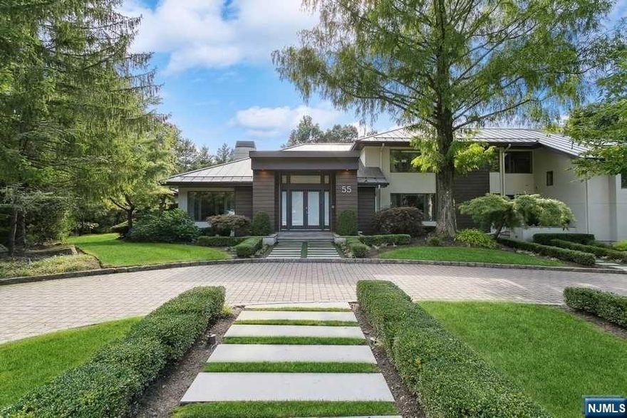 This exquisite smart home on a flat one-acre lot in Tenafly's most picturesque cul-de-sac offers the pinnacle of modern, luxurious living. Included is a stunning cabana alongside a beautiful pool, perfect for relaxation and entertainment. Step inside to find a main floor with an elegant entry foyer leading to an open floor plan. The family room, formal living room, and sit-in kitchen with a breakfast area create an inviting atmosphere. The kitchen is a chef's dream, equipped with top-of-the-line appliances and ample space. Also on this level are a guest bedroom with a full bath, an office, and an additional bath, plus a 3-car garage. Upstairs, the primary suite is a retreat with walk-in closets and an ensuite bath. Accompanying this are 3 additional bedrooms for kids and 2 full baths, ensuring comfort and privacy for all. The lower level is a haven of leisure, featuring 2 bathrooms, a bedroom, a gym, a theater, and a recreation area.