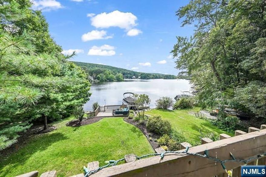 Welcome To This Beautiful Lakefront Home With Stunning Views On Private Upper Greenwood Lake! This 3 Bedroom, 2 Bath Lake Retreat Offers A Level Yard Leading You To The Water! When You Walk Into The First Floor, You'll Find A Bright Kitchen With High Ceilings, SS Appliances, Granite Countertops And Hardwood Floors! This First Floor Is Finished With A Dining Area, A Full Bath, 1st Bedroom And An Oversized Laundry And Utility Room! The Second Floor Includes A Living Room With A Stone Gas Fireplace And A Door To Your Private Balcony With A Spectacular View! The Second Bedroom Is Located Just Off The Living Room And This Floor Has A Large 2nd Bath! The Third Floor Is Your Loft Bedroom! Every Level Of This House Is Flooded With Natural Light! This Property Has A Large Deck As Well As A Deck On The Water! During Spring And Summer, This Yard Is Thriving With Hibiscus, Which Attracts Seasonal Hummingbirds To Come Feed! Enjoy Year-Round Lakefront Living With Motor Boating, Jet Ski, Swimmin