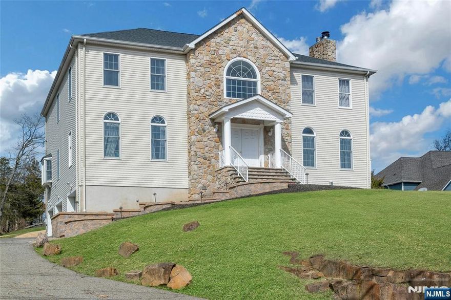 Welcome to this beautifully updated Colonial offering space, style, and modernized upgrades throughout. A newly paver walkway leads from the front door to an oversized driveway and three-car garage, setting the tone for whatâ€™s inside. This home features a brand-new custom kitchen with stainless steel appliances, fresh paint throughout, gleaming hardwood floors, a new roof, and newly updated central air. A welcoming foyer greets you as you walk through the front door and leads into a spacious living room and versatile family room or study with a wood-burning fireplace and stunning custom built-in bookshelves complete with a rolling ladder. A powder room and formal dining area complete the main level. Upstairs features four generously sized bedrooms, including a primary suite with two walk-in closets and a private bath with a jetted tub, stall shower, double vanity, and linen closet. An additional full bath with updated vanity serves the remaining bedrooms. Enjoy outdoor living on the new Trex deck overlooking a large, private backyard with endless possibilities. The full, unfinished basement offers excellent potential for future living space. Set in a highly sought-after neighborhood, this home offers peace, privacy, and natural surroundings while remaining conveniently located near top-rated schools, shopping, dining, major highways and NYC transportation. This home is expected to sell quicklyâ€”schedule your showing asap.