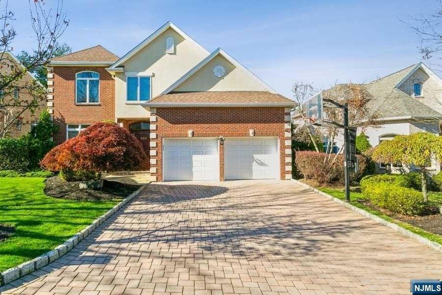 Fully renovated and move-in ready, this modern designed brick and stucco home is just minutes from NYC and has low taxes!! Bright foyer invites you into extra large formal living room with attached room that can be used as an office or playspace. Great room w/gas burning fireplace is open to the sleek eat-in-kitchen with custom cabinets, wine fridge, Miele appliances, walk in pantry and breakfast area. Oversized dining room is perfect for entertaining. Large windows throughout flood the house with light. Upstairs boasts a spectacular primary suite w/sitting area, renovated primary bath and 2 walk in closets, 2 bedrooms share bathroom, en-suite bedroom and laundry. Bathrooms come equipped w/Toto washlet toilets and radiant heated floors. The basement is perfect for play w/ additional bedroom and full bathroom. Backyard gets tons of sun with large deck. Attached 2 car garage, hard wood floors throughout and full house generator.