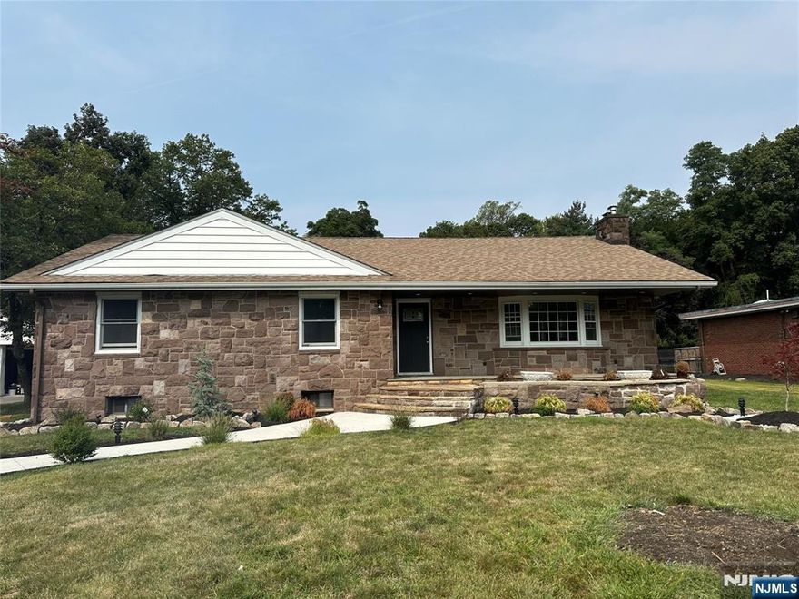 This is it, your dream home! Tucked away on top of Rifle Camp Rd. Come and see this fully upgraded top to bottom, custom ranch. This beautiful home sits on almost an acre of land! The exterior features custom locally sourced one of a kind red stone siding. Pull into your oversized driveway, up to the large detached garage with extra space for storage and its own dedicated power, enough for an EV charger or more. A large rear yard and brand new rear deck perfect for entertaining guests or enjoying your own secluded hideaway. With a wooded tree line in the back and the Great Notch Reservoir across the street you'd think you're in the countryside! Inside offers top of the line craftsmanship, all new appliances and total upgrades everywhere you can think! First floor boasts a large living room with a wood/gas fire place, a formal dining room and a brand new custom kitchen with all new top of the line "KitchenAid" appliances. Off of the kitchen is a half bath and laundry room, as well as the entrance to the sunroom with sliding doors out to the rear deck. Two bedrooms, a full bathroom, as well as the primary bedroom with primary full bathroom complete the first floor. The second floor boasts the fourth bedroom. The fully finished basement boasts a large living room, full bathroom, extra room for storage, utility room and a full size office/den with its own custom extended egress window. This home is everything you're looking for and more!