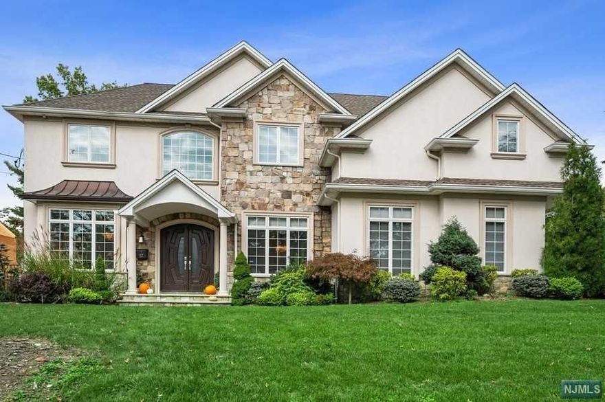 Built in 2014 & totally gut renovated in 2020, this stunning Tenafly home boasts 6,600sf of impressive living space. Grand 2-story foyer welcomes to 1st floor featuring large dining room w/butler's pantry, sun-drenched living room, 2-story great room w/gas fireplace, large ensuite bedroom, P/R and a bright chef's kitchen w/Wolf appliances & breakfast that opens to backyard complete w/entertainment patio, pool & outdoor kitchen. Primary suite w/double sided fireplace separating bedroom & vaulted ceiling sitting room, spa like bath w/jetted soaking tub, dual vanities and dual walk-in-closets found on 2nd floor. 3 additional bedrooms, 2 full baths & laundry room complete second level. Full finished basement w/10' walkout, full wet bar, 2 large rec areas, bedroom & full bath. Updates include all new bathrooms, smart home controlling heat, lights, sound system and cameras in & outside the home. 3 car heated garage, whole house generator, central vac - This home has it all. A MUST SEE!