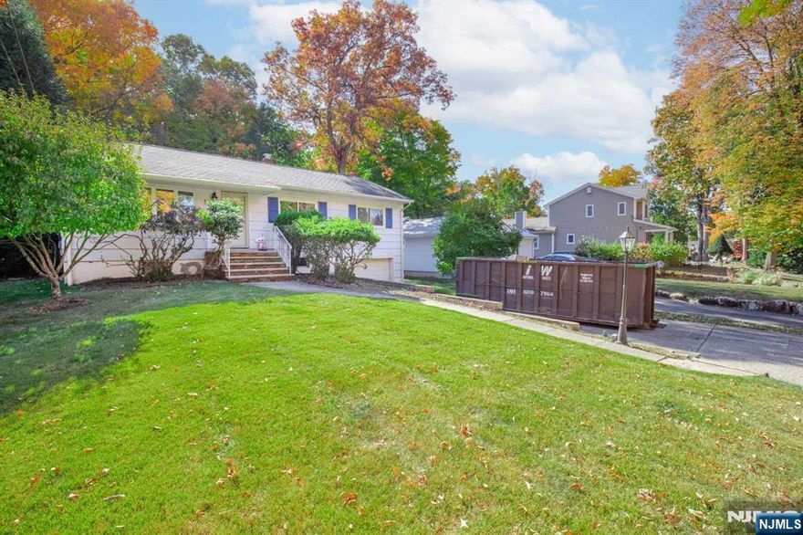 For more information on this home please contact Geno Russo- 201-273-1144 Perfectly positioned on a flat 0.295-acre lot, this beautifully maintained home offers hardwood floors throughout the mirrored living room and a bright dining area. Step out onto the oversized deck, overlooking a tranquil level backyard ideal for outdoor gatherings. The sunlit kitchen, complete with a skylight, abundant cabinetry, stainless steel appliances, and a cozy breakfast nook, is a chef's delight. Just steps away are two inviting bedrooms and a full bath. The spacious primary suite boasts dual closets and additional wall-to-wall storage. A fully finished basement features a rec room, bonus office space, and ample storage, with a laundry/utility room leading to the attached one-car garage. Experience Oakland's charm and sustainability this home is waiting for you!