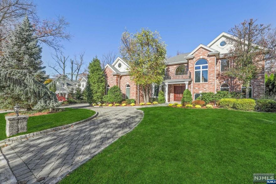 NORTH CLIFFS! Stately Brick Colonial set on an oversized property on a cul-de-sac street in walking distance to NYC transportation. This 5 Bedroom 5.5 Bath home was built in 2003 with large bright rooms, oversized windows and high ceilings. The Main Level features a Grand Entrance Foyer leading to a double height Great Room that is adjacent to a Gourmet Kitchen and Breakfast Area. A Living Room, Dining Room, Bedroom Suite with a private patio, Guest Powder Room and a 3 Car Garage complete this level. The Second Level consists of a Primary Bedroom Suite with Sitting Room, a Bedroom Suite and two additional Bedrooms with an adjoining Bathroom. The Basement is fully tiled with a built-in Bar and a full Bathroom. The rear property is perfect for entertaining with a flat yard and a large paver patio. Radiant Heat - Backup Generator - Low Taxes - Minutes from Manhattan.