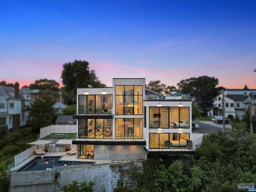 Introducing the Edge of Luxury Living - welcome to an architectural masterpiece nestled in an exclusive enclave cantilevered on a bluff echoing the modern brilliance from the California Coast. This newly-built multi-level home transcends conventional luxury while offering unparalleled views stretching frm the GWB to the Statue of Liberty. Meticulously crafted, this residence features an expansive floor plan over 6 floors maximizing the mesmerizing midtown Manhattan skyline views w floor to ceiling windows & multiple balcony/lounge area retreats. The ultimate in entertaining, the outdoor paradise features an expansive rooftop deck w skyline vistas, 4 balconies & a pool/spa oasis complete w an outdoor kitchen. Indulge yourself in the state-of-the-art finishes starting w the oversized designer eat-in kitchen, radiant heating throughout, high-end TileBar bathrms, & the latest in home automation w Lutron lighting,smart motorized shades & more. Make this iconic cityscape your backdrop