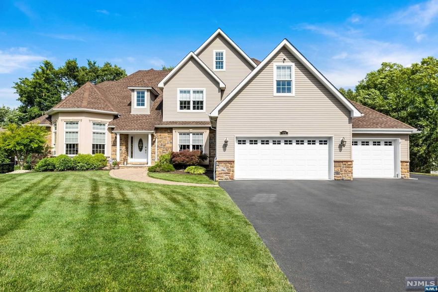 Stunning newer colonial on a quiet cul-de-sac. This home is immaculate and has every feature the discriminating buyer desires. Hardwood throughout, gas fireplace, granite countertops, high ceilings. Juliet balcony overlooking 2 story entrance foyer. Chandelier has a lift for cleaning. 4 car heated garage (2 side-by-side and 2 tandem) with epoxy floor and upgraded lighting. Master bedroom has spacious, custom walk-in closet and en-suite bathroom with jacuzzi tub plus shower stall. Laundry is on same floor as bedrooms. 4000 square feet of luxury living plus full, unfinished basement. Move right into this beauty