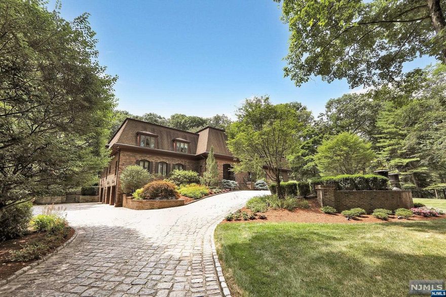 A stately circular stone driveway and elegant outdoor lighting set the stage for this classic home on a desired & premier cul de sac!The entrance reveals stunning bridal staircases flanked by an impressive dining room and formal living room designed for both large & intimate gatherings. Continue into an expansive 2 story great room with stone FP,wet bar & vaulted beam ceilings overlooking the luxury pool & resort-like patio. The ground floor also offers a striking home office, a guest suite, and the true heart of this home is a spacious custom kitchen with two granite islands,sitting area with stone fireplace, breakfast nook, wall of windows with walkout to lush property. Upstairs the immense primary suite offers both sauna and jacuzzi & 3 WICs. 2 more generous bedrooms provide window seats & Jack/Jill bath.Radiant heat in ceiling! Lower level offers a wine cellar,family room with stone FP & exercise room. Full house generator and EV charging station!