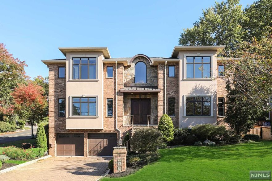 Young (2015) Brick and Stone Center Hall Colonial boasting high ceilings, an open floor plan and quality modern finishes. The Main Level features a two story Entrance Foyer with a dramatic circular stairway, a large Modern Kitchen that opens to a double height Great Room with floor to ceiling windows, an oversized Dining Room, Living Room, Guest Power Room and an En-Suite Bedroom. The Second Level includes a large Primary Bedroom Suite, 3 additional Bedroom Suites and a Laundry Room. The Primary Suite boasts a large Bedroom, a well appointed Bathroom and two walk-in closets. The Lower Level is beautifully finished with many large windows and granite flooring with radiant heat. There are two large Recreation Rooms, a Bedroom, Bathroom and an exit to a huge 2 Car Garage. Finishes include: elegant mouldings, dramatic ceilings, hardwood floors, radiant heat, whole house generator and more. Walk to NYC transportation and restaurants. MOVE RIGHT IN!