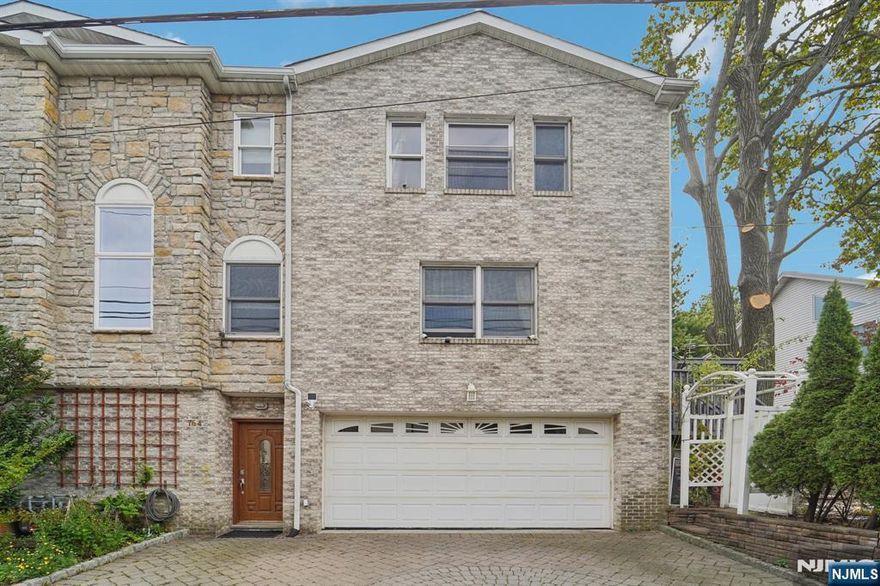 Welcome to this young, custom-built, duplex-style brick home conveniently located in Cliffside Park on the Fort Lee border! Featuring 3 bedrooms, 3.5 baths and an oversized 2-car garage, this townhome on a tree-lined quiet street also offers a large deck and spacious yard. The main level is perfect for today's lifestyle with an open layout boasting cherry hardwood floors throughout, a gas fireplace, gourmet kitchen with granite counters and high-end appliances, and corner walls of windows allowing abundant natural light. The kitchen has access to a private deck with stairs to the fenced-in yard for gardening and outdoor enjoyment. A guest bedroom with full-bath complete the main floor. The upper level features an oversized primary suite with tray ceilings, walk-in closet and bath with jacuzzi, along with another large third bedroom with a full hall bath. Central A/C, first-floor laundry, and an oversized tiled garage complete this modern home. Come visit and make it yours!