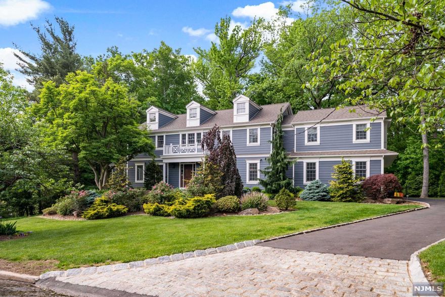 This magnificent 5 bedroom 5 1/2 bathroom Colonial home rebuilt and expanded in 2012 is graciously set on a private lushly landscaped .7 acre on an Englewood East hill cul-de-sac.Sunlight streams into the front double height entry foyer leading to the dining room with butlers pantry and living room with french door.Large family room with beautiful gas fireplace and coffered ceiling is open to the Gourmet kitchen with large butcher block center island and stainless steel appliances.Breakfast room with pantry has sliding glass doors to the backyard.Guest bedroom with full bathroom ,mudroom,3 car heated garage completes the first floor.Stunning master bedroom with 2 custom walk in closets and spalike master bathroom plus 4 additional bedrooms,1 with an ensuite bathroom,hallway bath, office and laundry room. Lower level with recreation room, full bath, storage room and office.Multiple zone baseboard heating,central air conditioning and generator complete this perfect home.